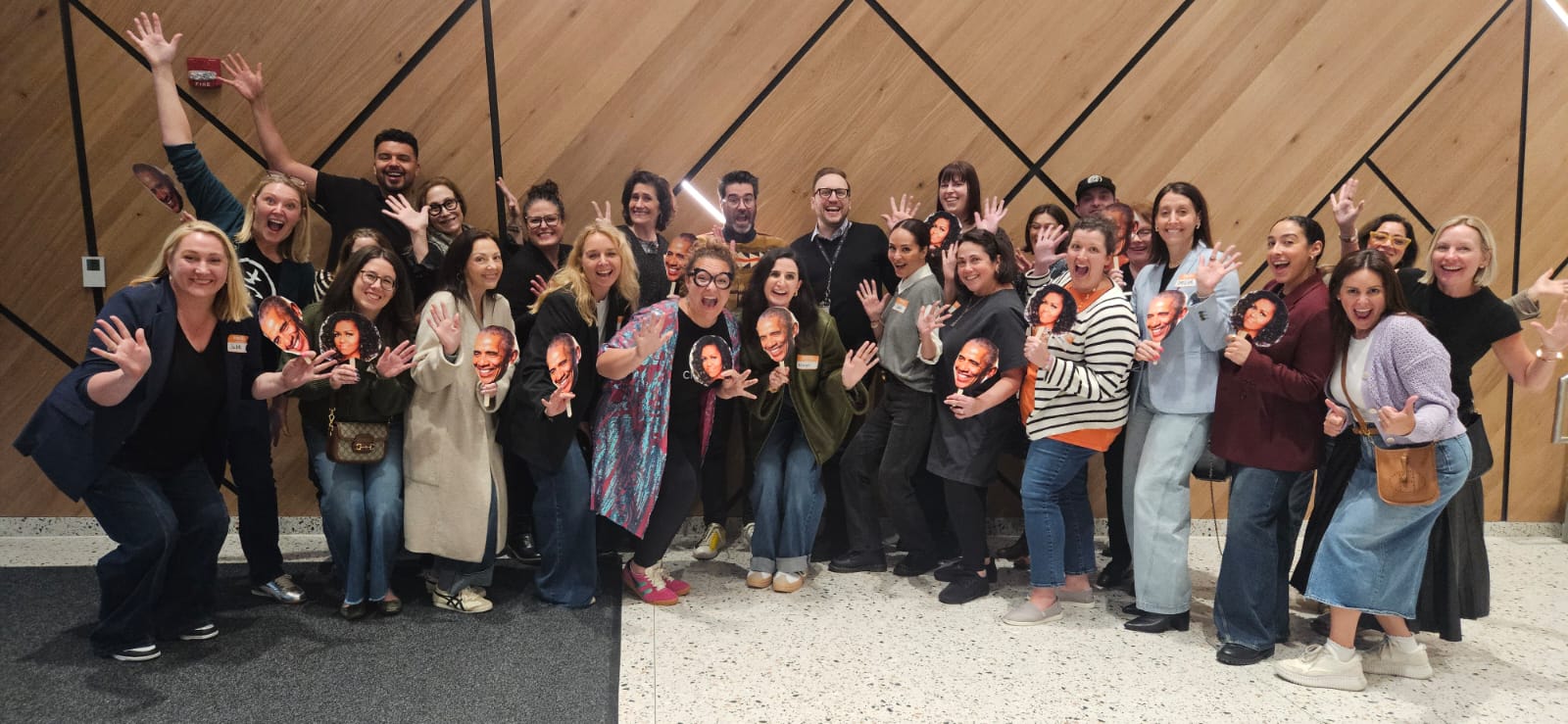 Group photo with celebratory cutouts at a Buyers Club event