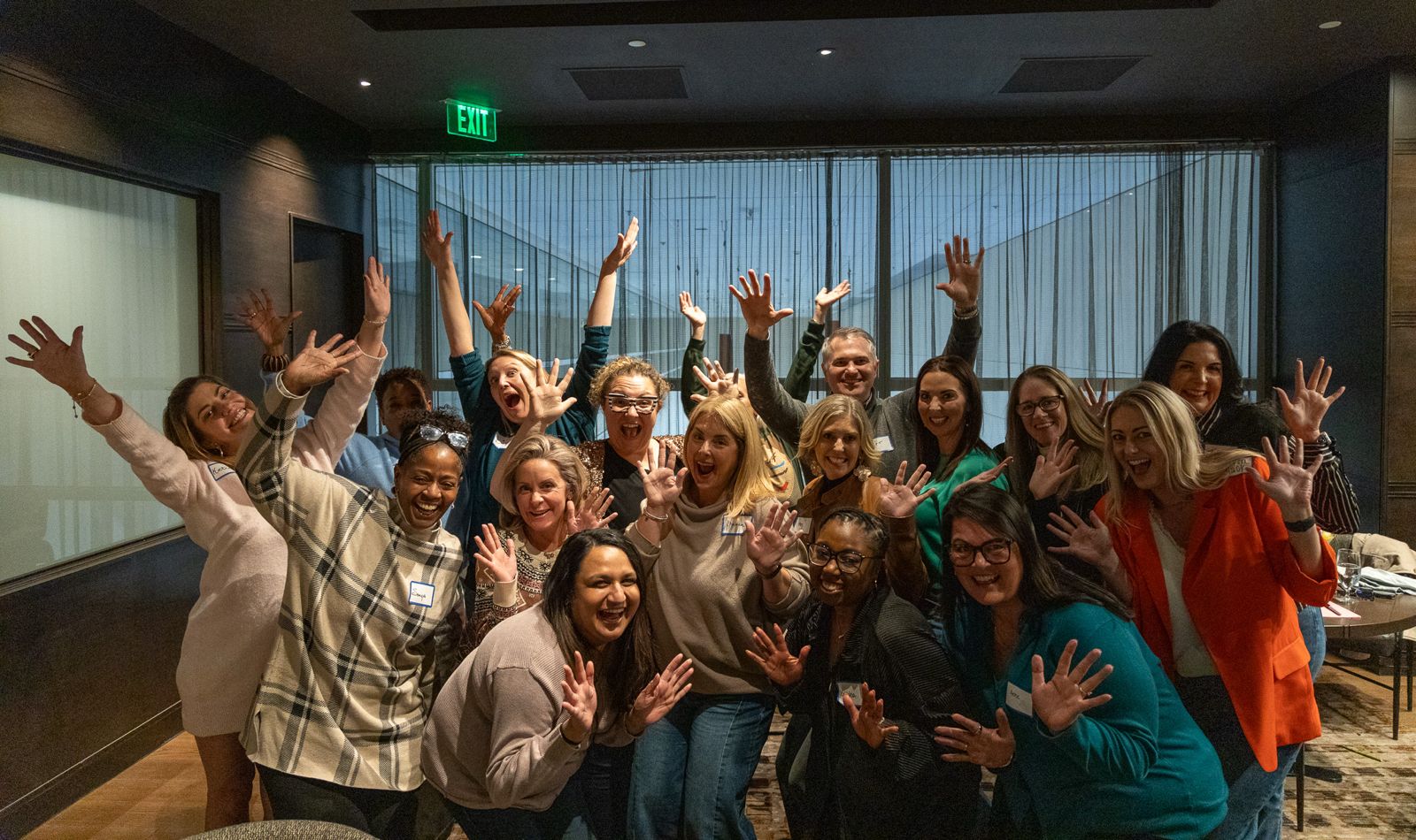 Buyers Club group waving during a roundtable session